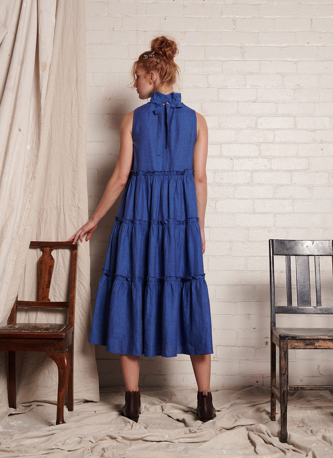 A blue, sleeveless, pure European linen, tiered dress with ruffled collar and detailing