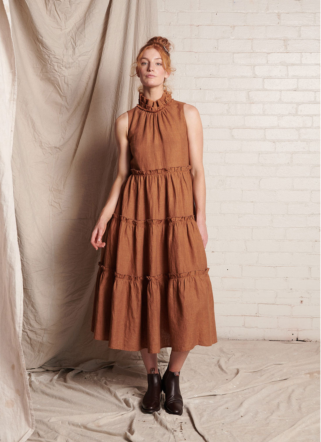 A bronze, sleeveless, pure European linen, tiered dress with ruffled collar and detailing