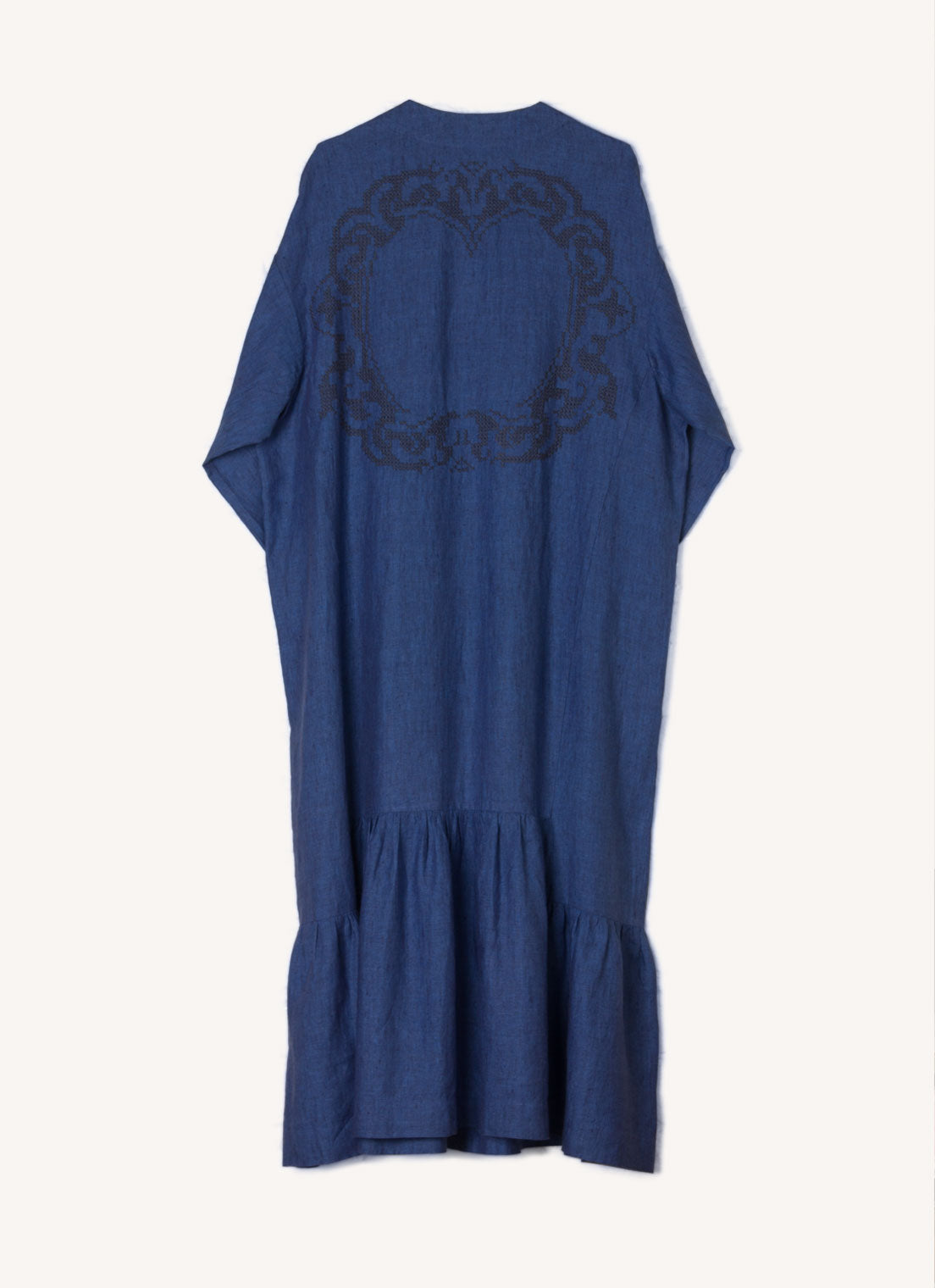 A blue, easy fit, midi-length dress with round neckline, long sleeves, centre front button fastening, flounced hem and embroidered detail at the back made from European pure linen