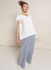 An indigo and white gingham, wide-leg pants with wide and elasticated back waistband and side pockets in small gingham yarn dye washed linen