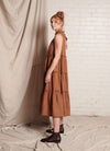 A bronze, sleeveless, pure European linen, tiered dress with ruffled collar and detailing